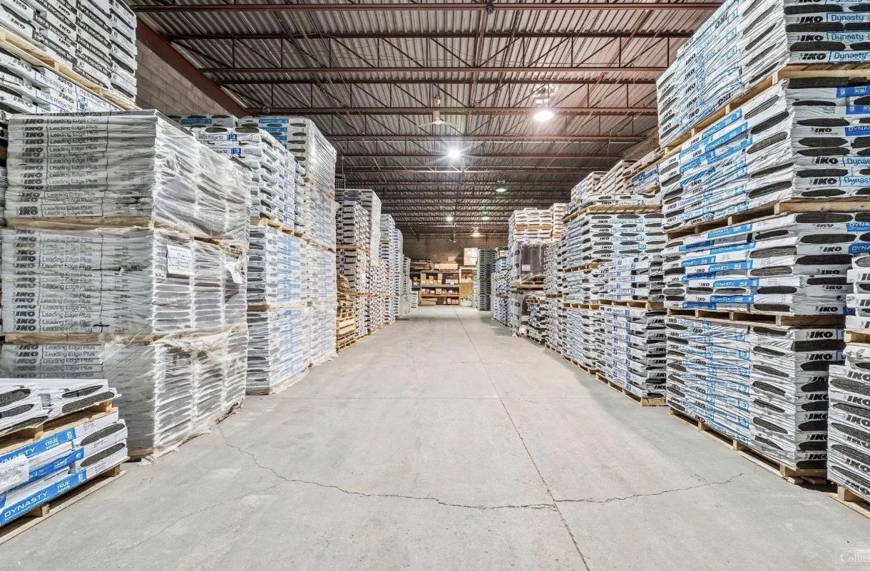 Warehouse aisle stocked with roofing shingles